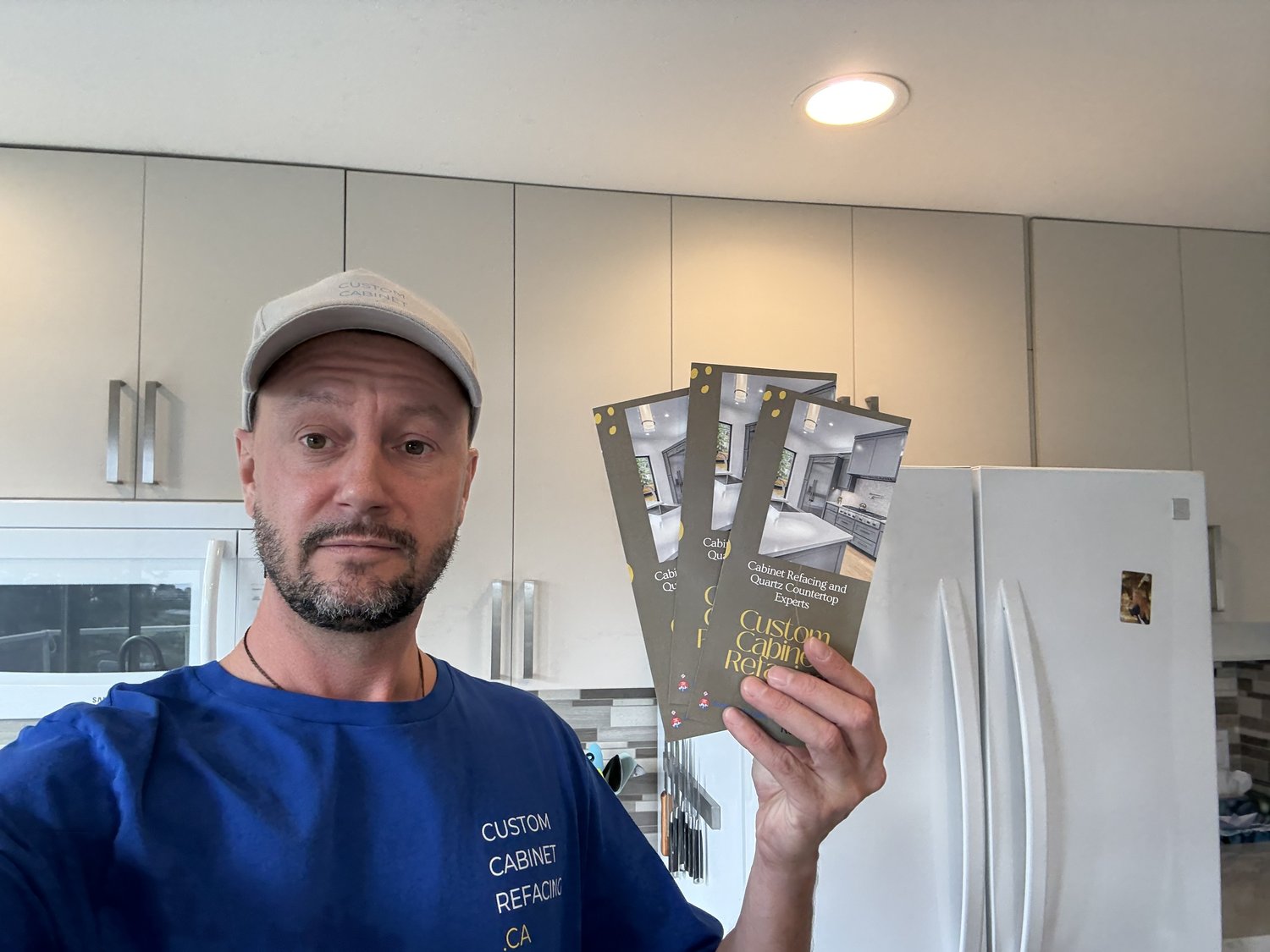 Blake at a finished Kelowna kitchen with Custom Cabinet Refacing brochures