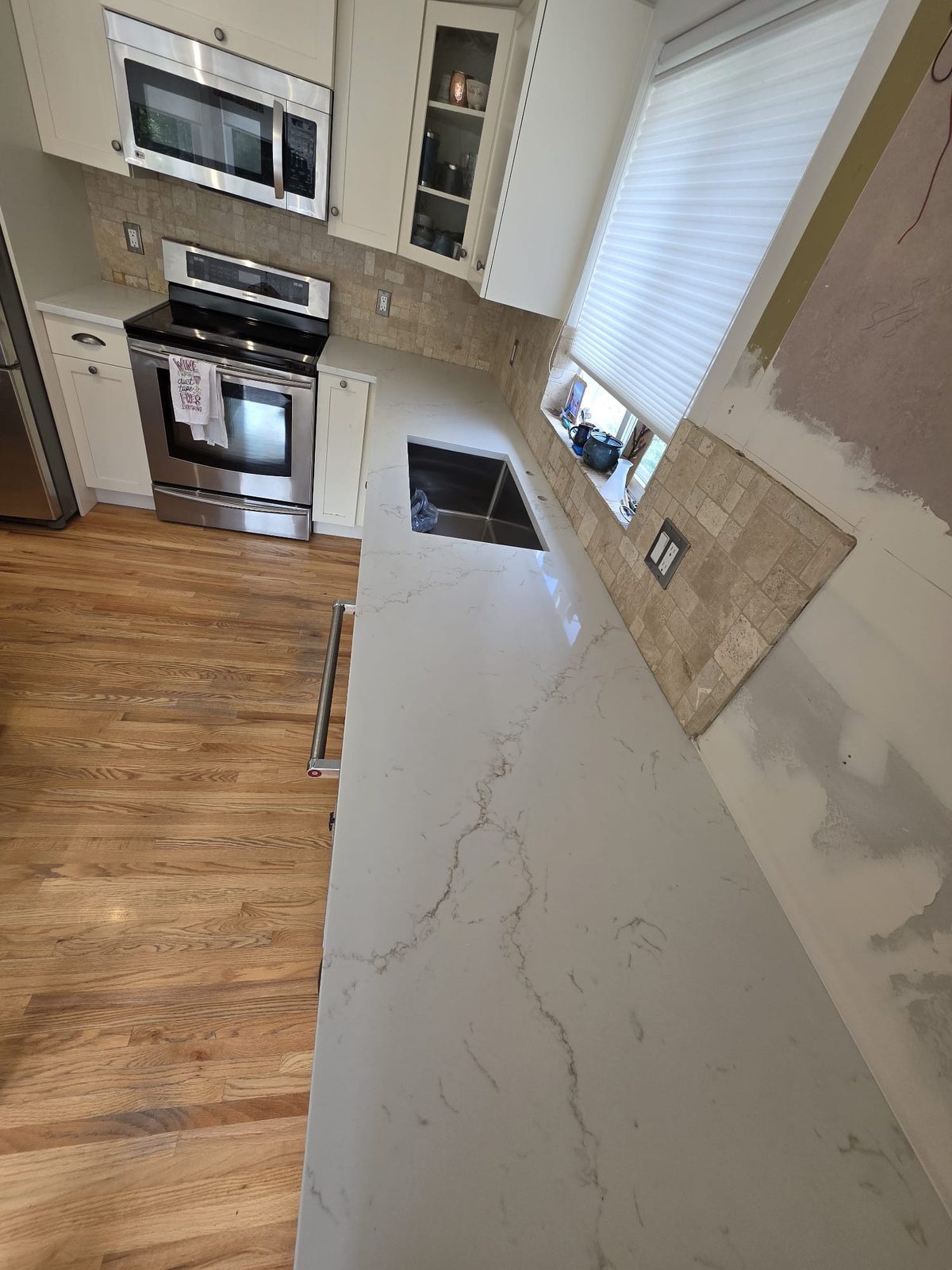 White marble-look quartz with waterfall edge in Kelowna