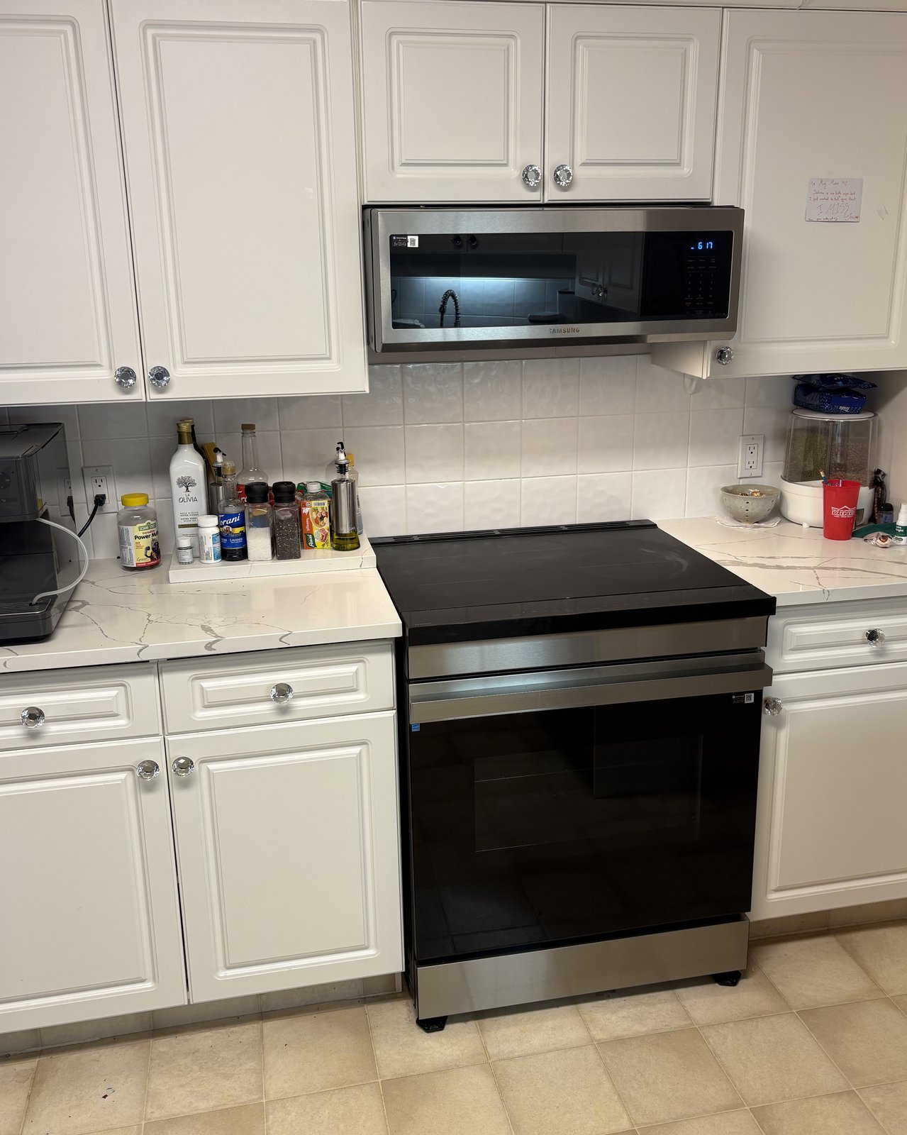 Kelowna kitchen before refacing — white raised-panel doors